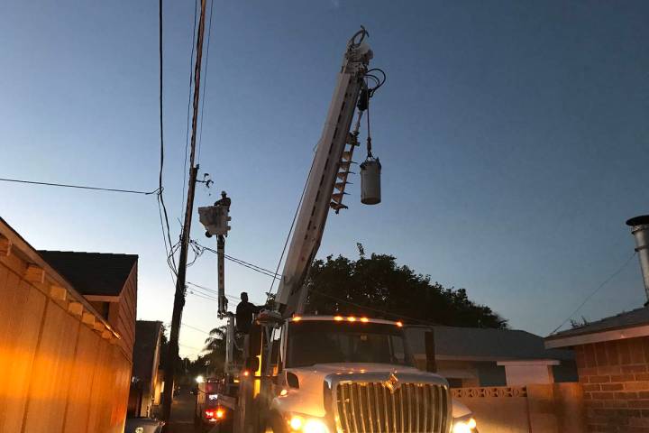 (Norma Vally) A crew from the utility department repairs a transformer “can” that ...