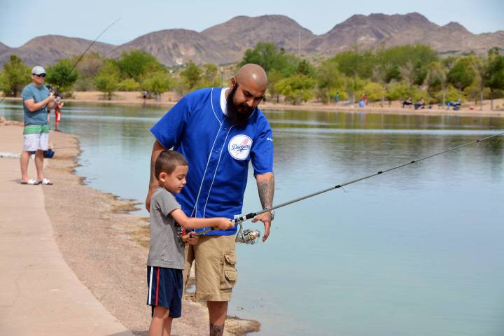 (Celia Shortt Goodyear/Boulder City Review) Juan Santos helps his son, Angel Santos, fish durin ...