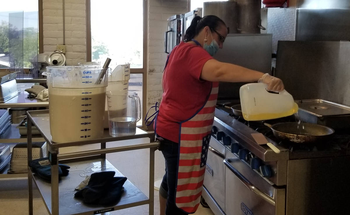 Celia Shortt Goodyear/Boulder City Review Shannon Chavez oils the griddles to make more pancake ...