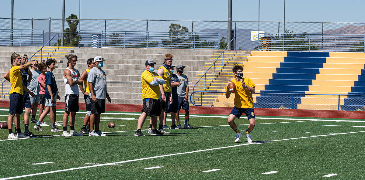 (Jamie Jane/Boulder City Review) Senior Matthew Felsenfeld, center, prepares to pass the ball T ...