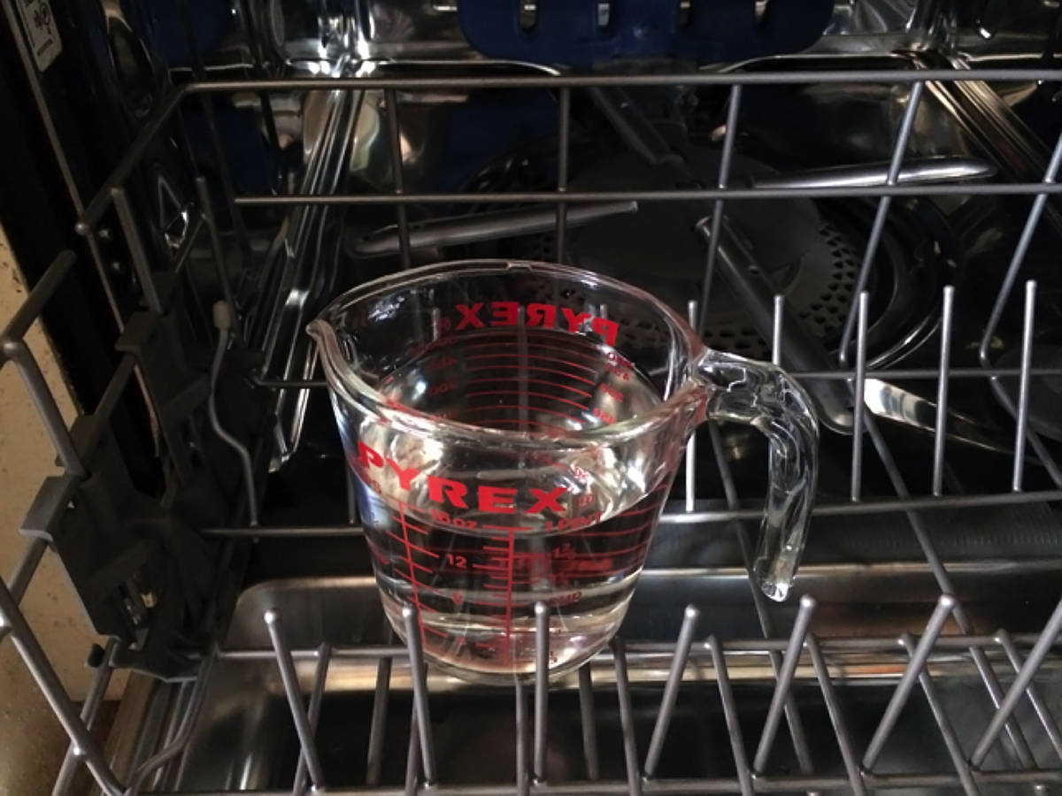 (Norma Vally) Clean your dishwasher by placing 2 cups of white distilled vinegar in a container ...
