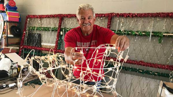 Dale Ryan tests the light bulbs on a sleigh that was given to him to use in the massive holiday ...