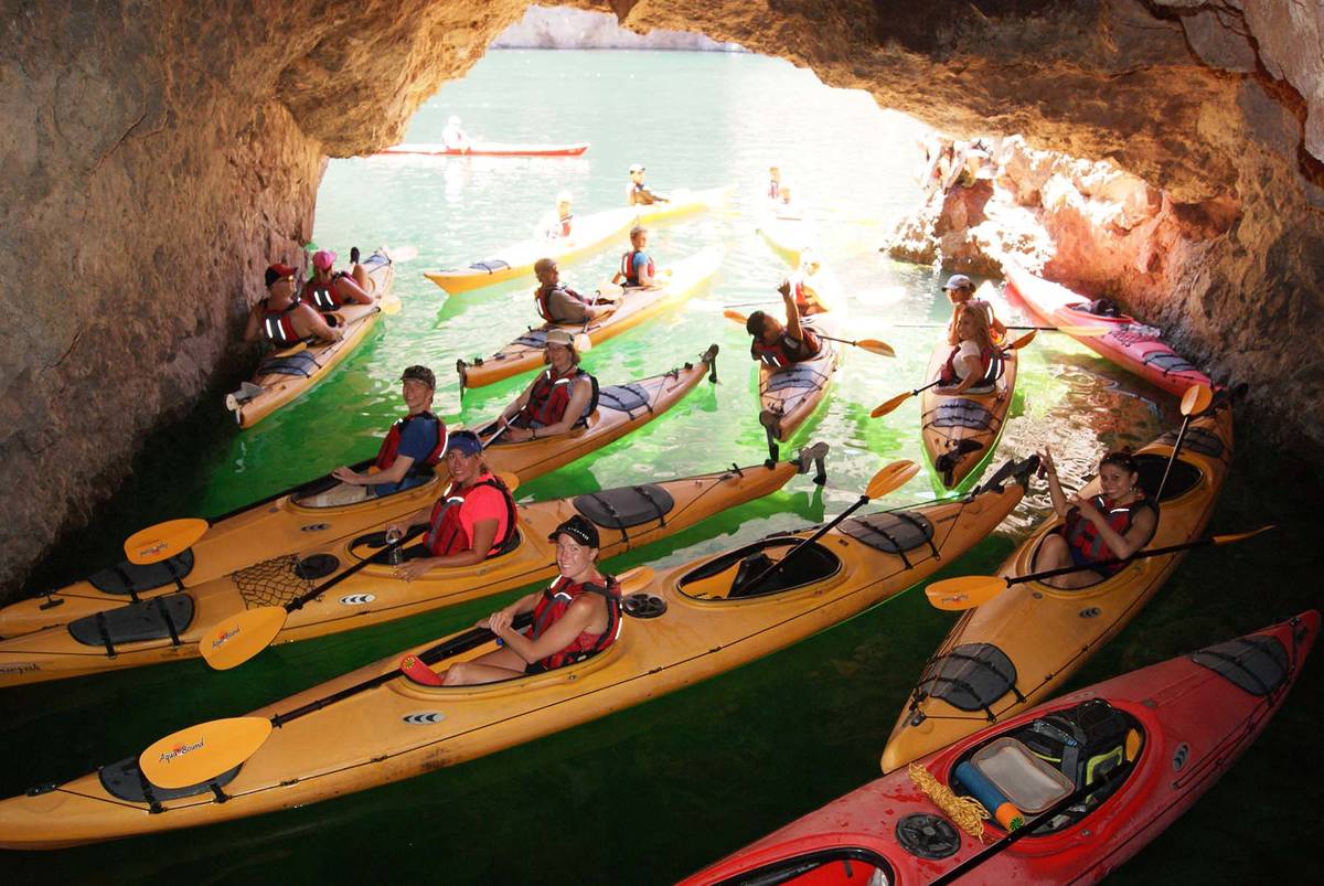 (Evolution Expeditions) Kayakers stop inside Emerald Cave during one of Evolution Expeditions&# ...