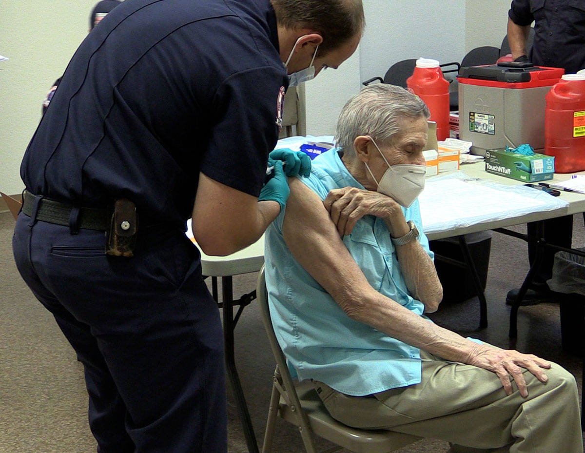 Boulder City Boulder City Firefighter Nick Giles gives resident Joe Lambert the COVID-19 vaccin ...