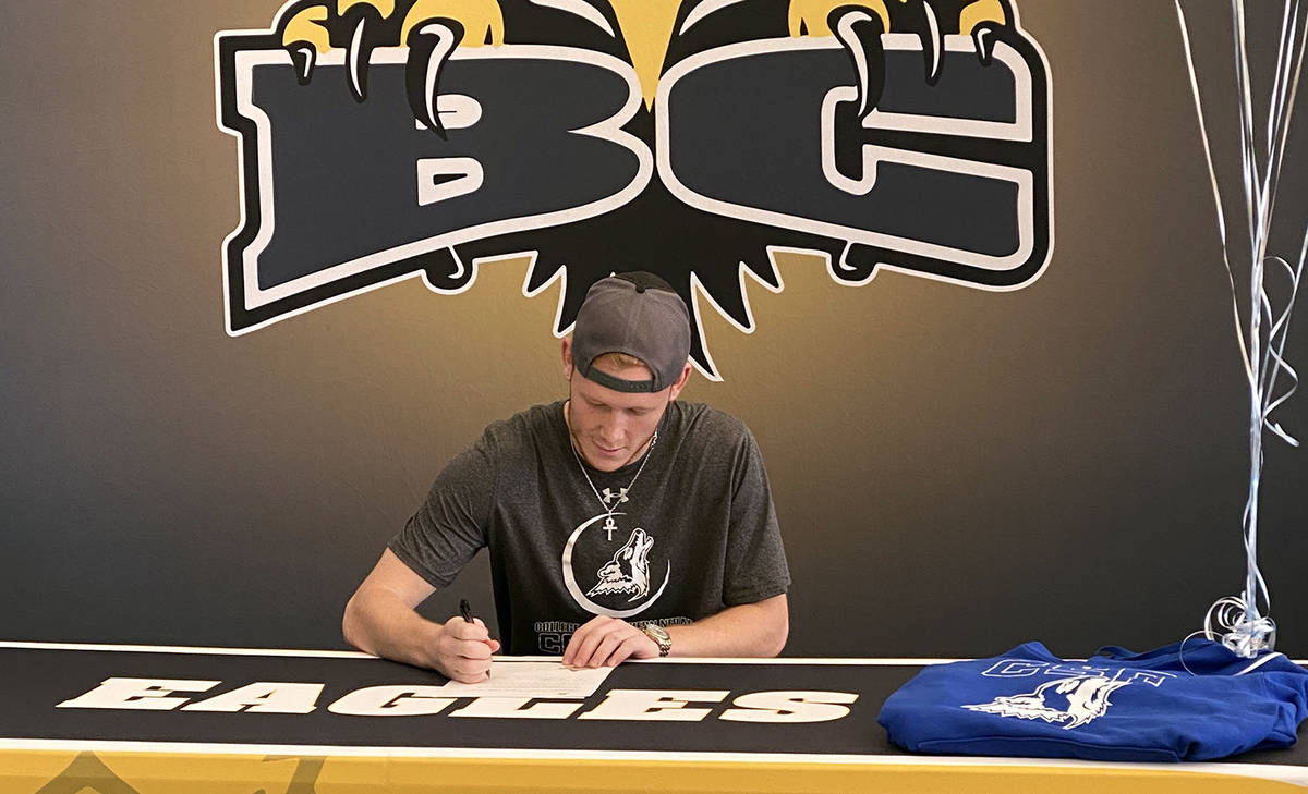 (Morton family) Matt Morton, a recent graduate of Boulder City High School, signs his letter of ...