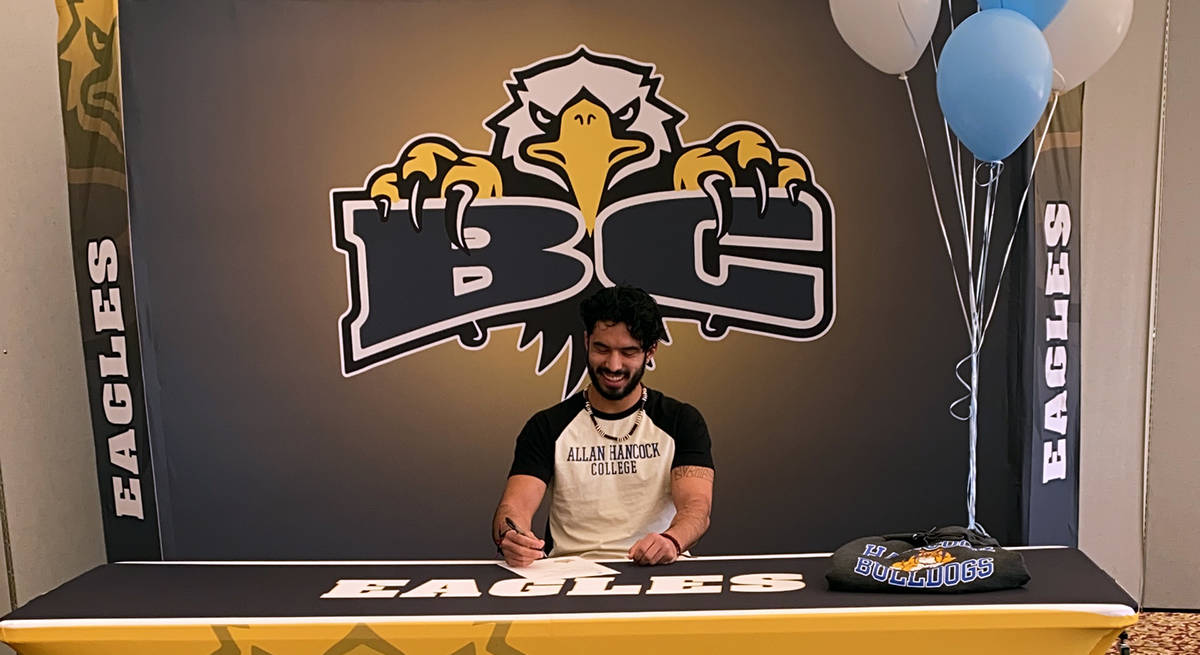 (Davis family) Trey Davis, a senior at Boulder City High School, signs his letter of intent to ...