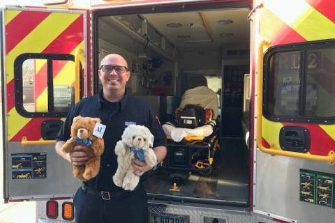 Boulder City Fire Department Boulder City firefighter Brian Shea holds teddy bears that are gi ...