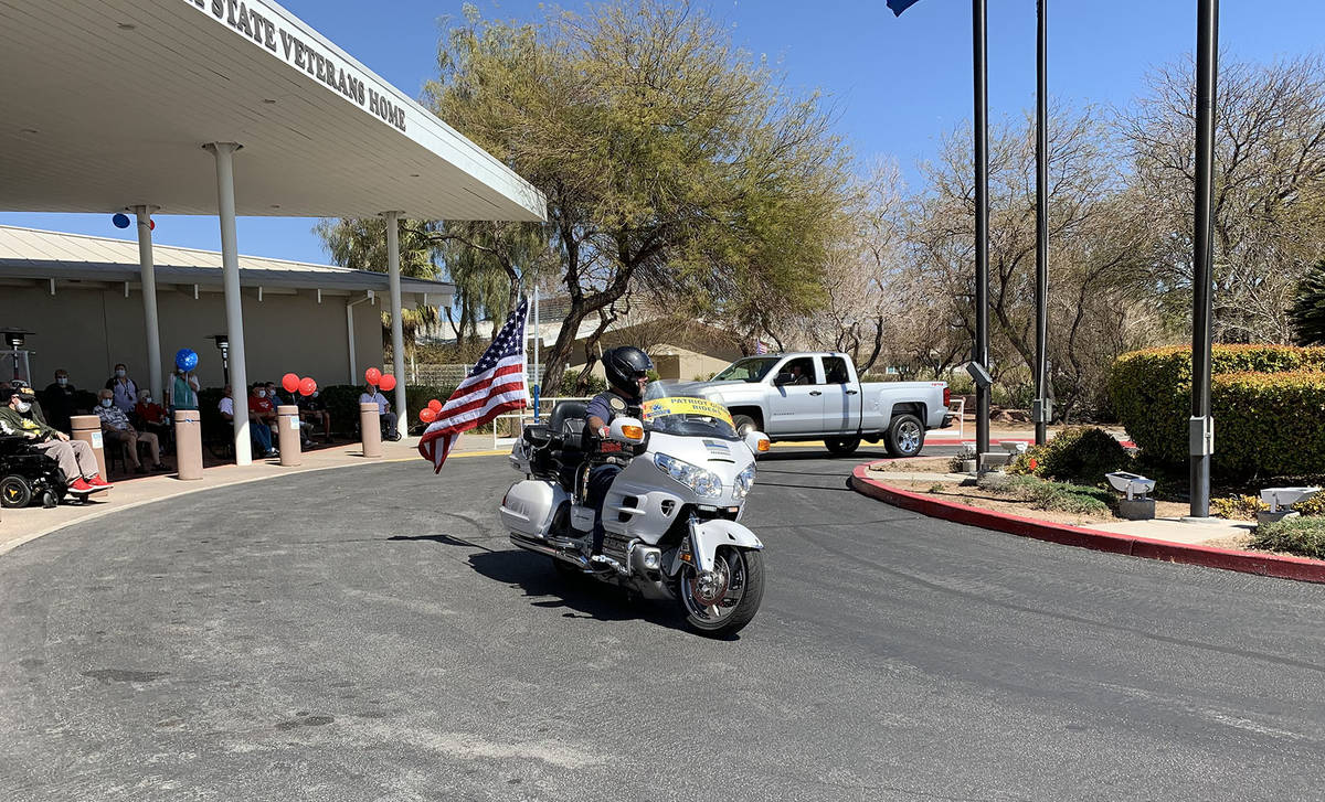 (Hali Bernstein Saylor/Boulder City Review) A motorcyclist flies an American flag as he passes ...