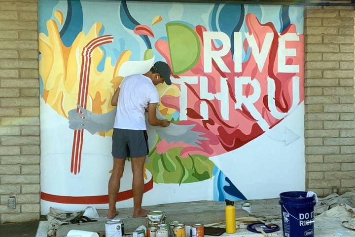 Seth Woodbury Recent Boulder City High School graduate Seth Woodbury paints a mural at the driv ...