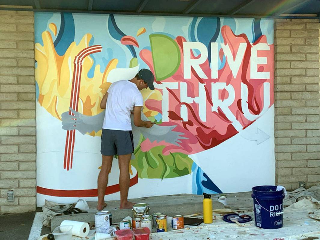 Seth Woodbury Recent Boulder City High School graduate Seth Woodbury paints a mural at the driv ...