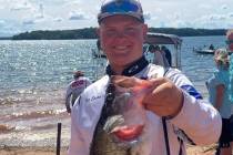 (Bri Osman Easter) Izec Easter holds up his 4-pound, 14-ounce fish, which was the 10th biggest ...