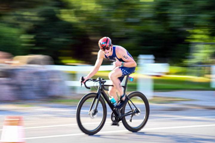Eduardo Miler Cruising down the bike path, Ethan Porter glides down the lane at the Wasatch tri ...
