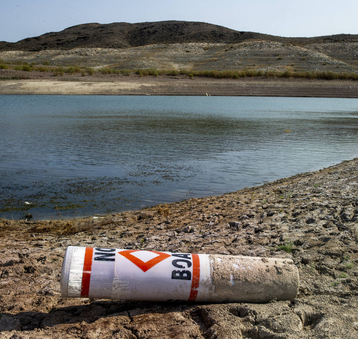 (L.E. Baskow/Special to the Boulder City Review) A buoy sits on the shore from low water near B ...