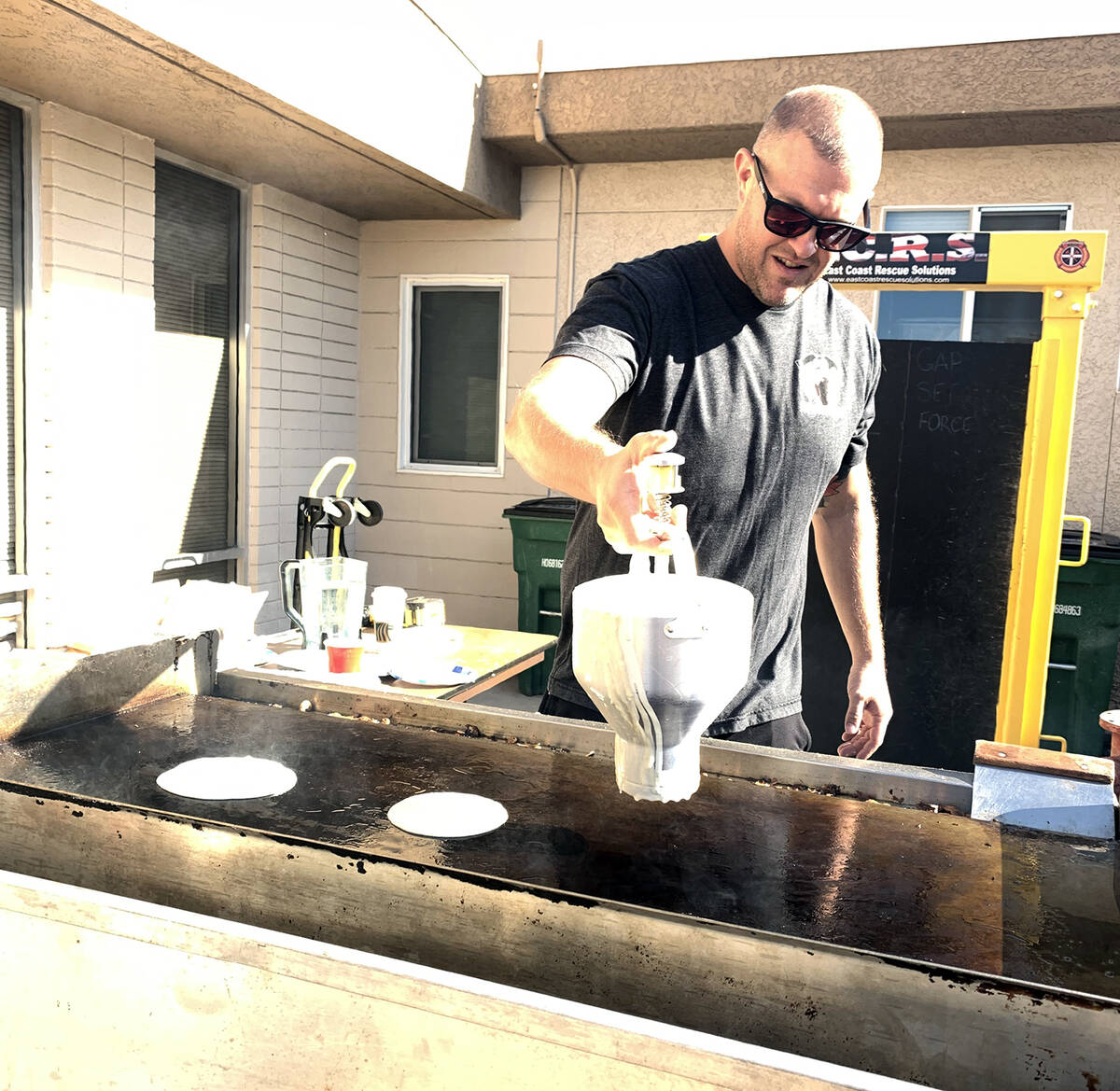 (Hali Bernstein Saylor/Boulder City Review) Firefighter Brandon Featherly makes pancakes for th ...