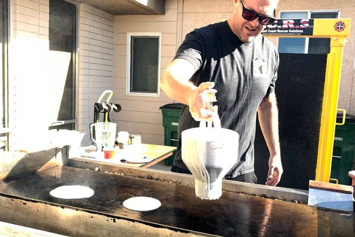 (Hali Bernstein Saylor/Boulder City Review) Firefighter Brandon Featherly makes pancakes for th ...