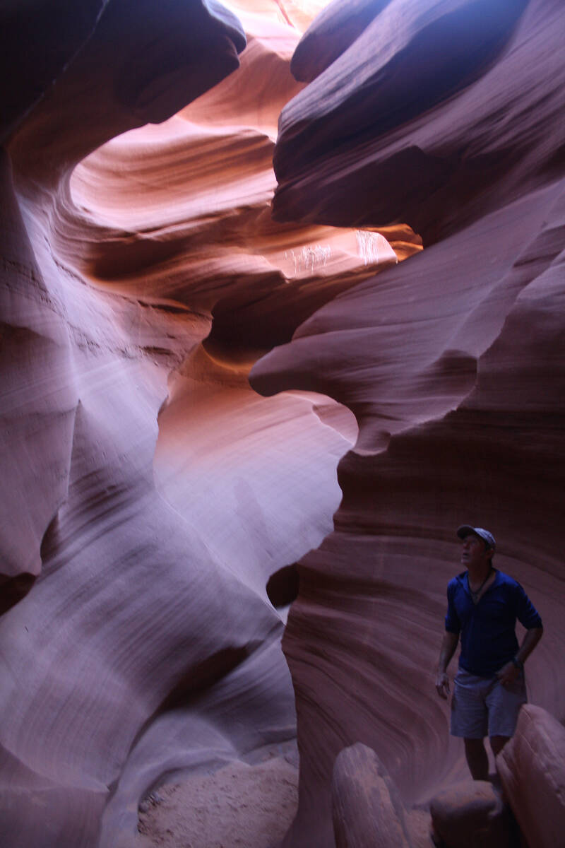 (Deborah Wall) A visitor checks out Lower Antelope Canyon on the Navajo Reservation near Page, ...