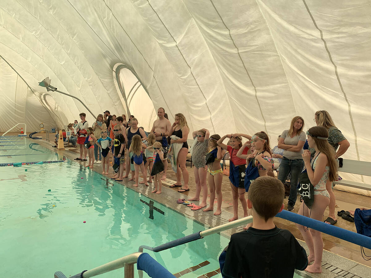 (Hali Bernstein Saylor/Boulder City Review) Children line up at the edge of the pool waiting th ...