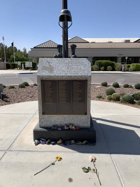 (Hali Bernstein Saylor/Boulder City Review) Painted stones and flowers were placed before a mem ...