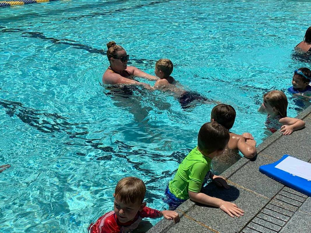 (Hali Bernstein Saylor/Boulder City Review) Katie Tyler helps a young boy learn how to swim saf ...