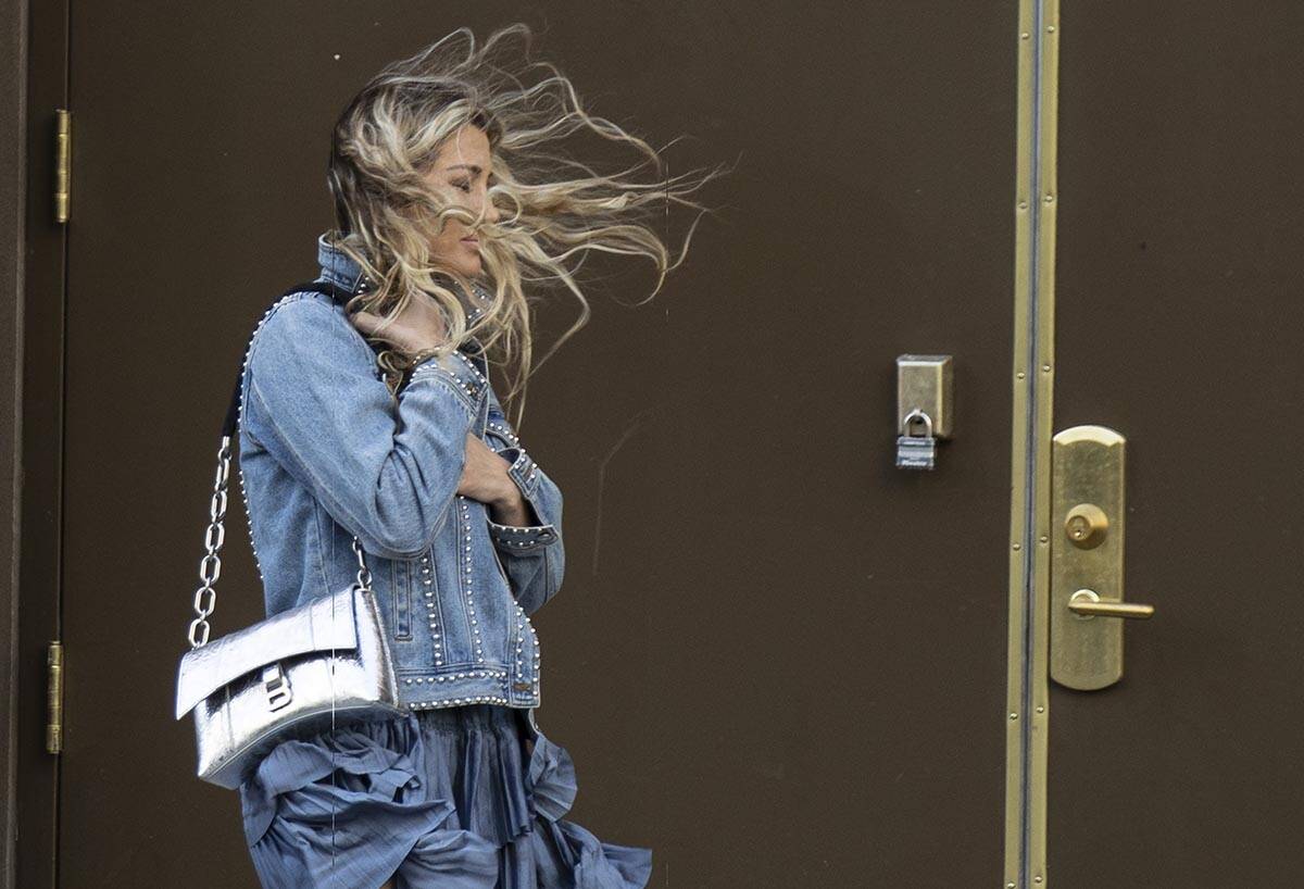 (Las Vegas Review-Journal file photo) A pedestrian has her hair blown by strong wind as she wal ...