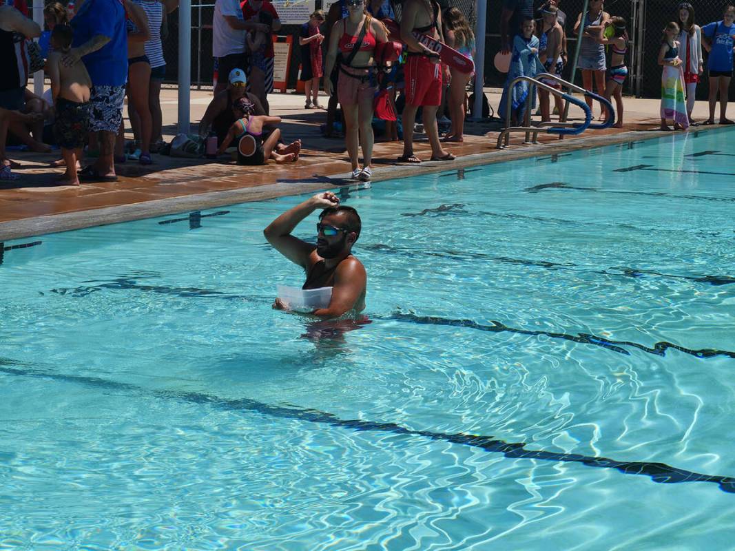 (Owen Krepps/Boulder City Review) Lifeguard James Walsh refills the pool with coins for the nex ...