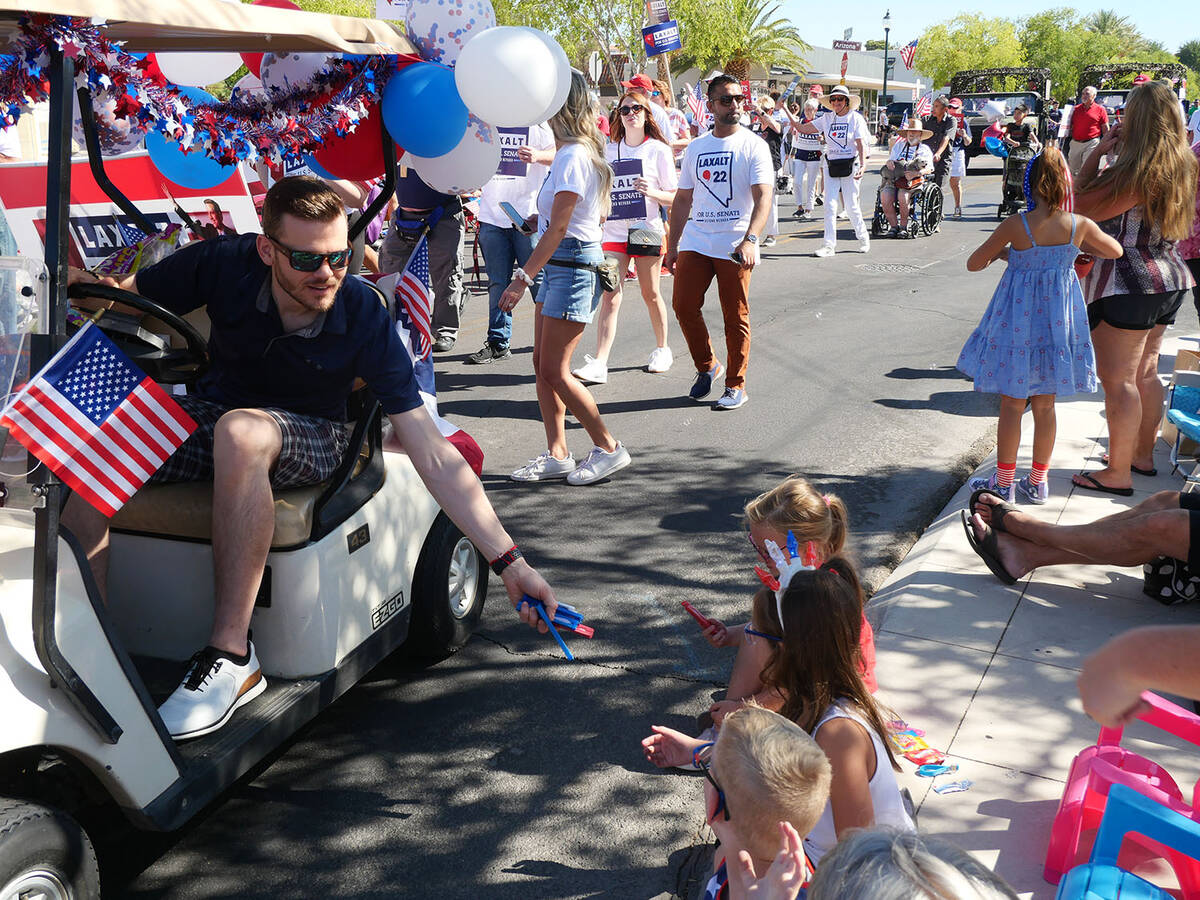 (Owen Krepps/Boulder City Review) City Manager Taylour Tedder hands out candy to children while ...
