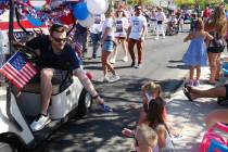 (Owen Krepps/Boulder City Review) City Manager Taylour Tedder hands out candy to children while ...