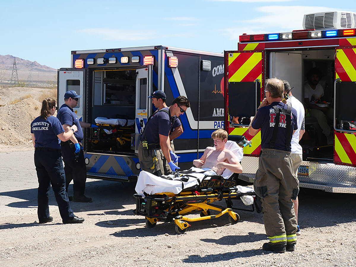 (Owen Krepps/Boulder City Review) A man is checked for injuries by paramedics and firefighters ...
