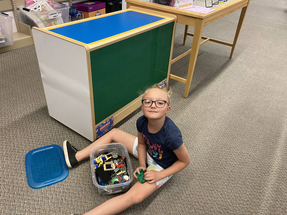 (Owen Krepps/Boulder City Review) Emma Clark plays with the new Lego wall at the Boulder City L ...