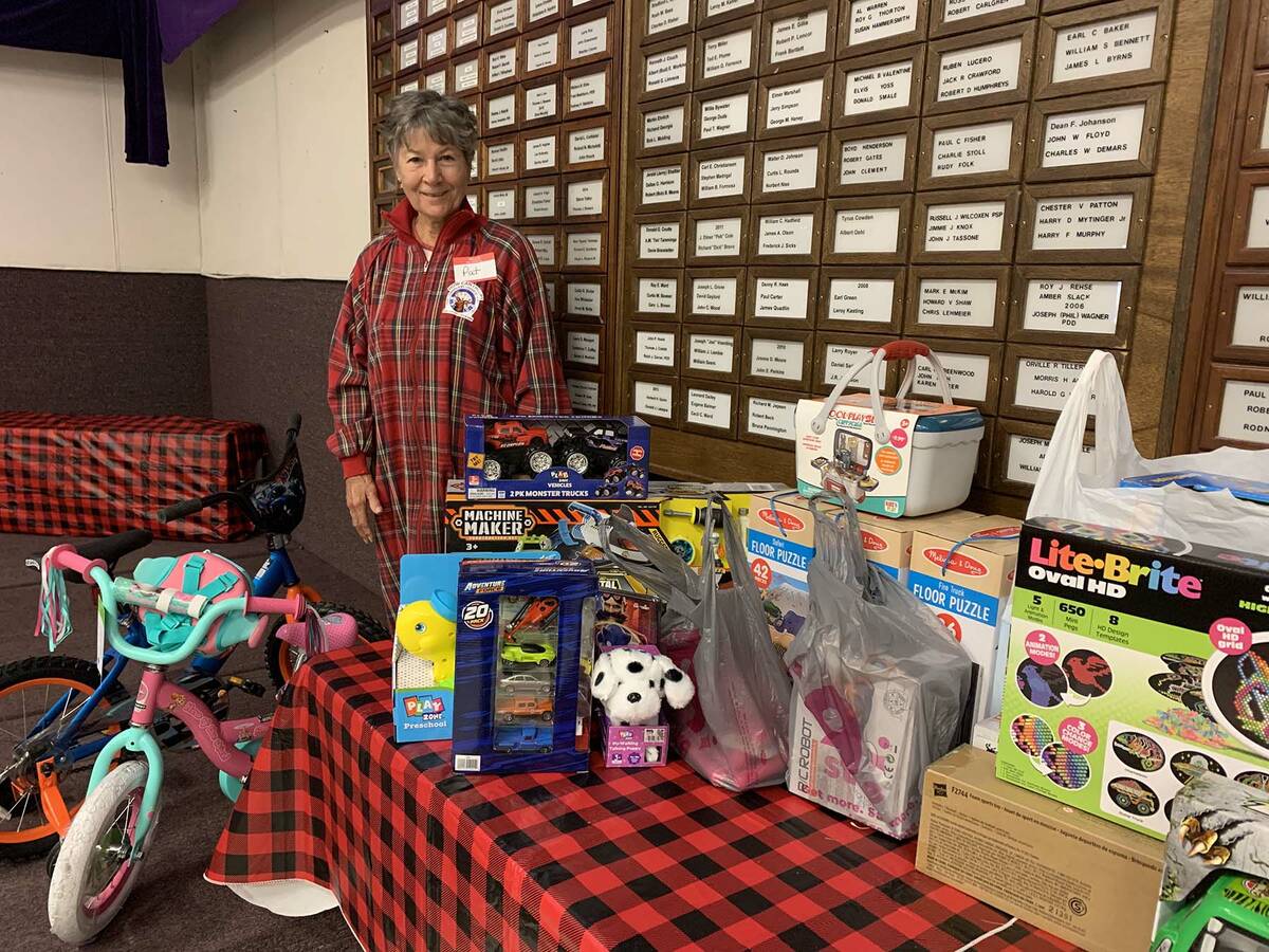 (Hali Bernstein Saylor/Boulder City Review) Pat Benke shows some of the toys that were donated ...