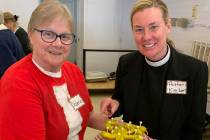 (Hali Bernstein Saylor/Boulder City Review) Valerie Chapman, left, prepares to serve the Rev. K ...