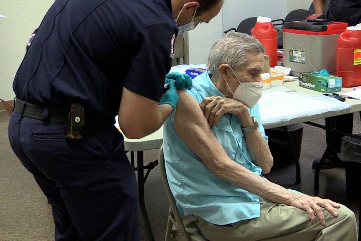 (File photo) Boulder City Firefighter Nick Giles gives resident Joe Lambert the COVID-19 vaccin ...