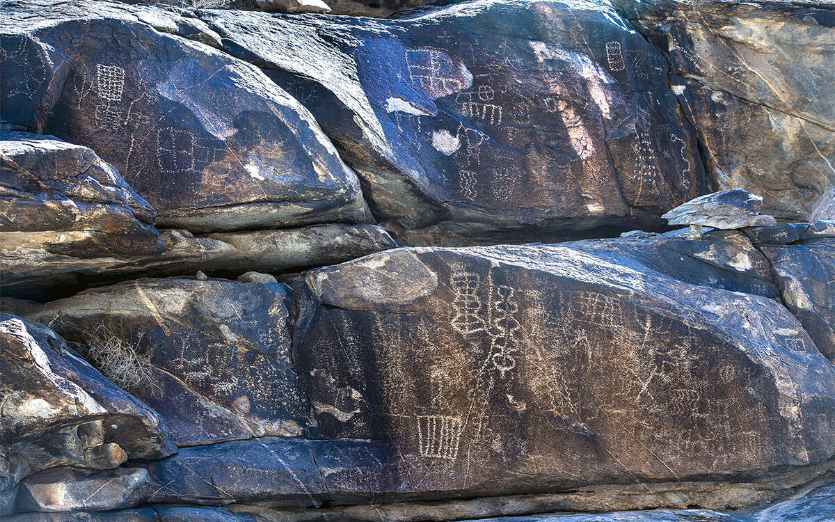 (L.E. Baskow/Las Vegas Review-Journal) Native American petroglyphs line the rock walls along th ...