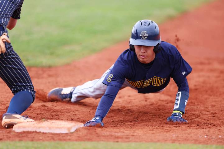 Boulder City's Landon Baker (46) slides back to first day safely after a check by a Spring Vall ...