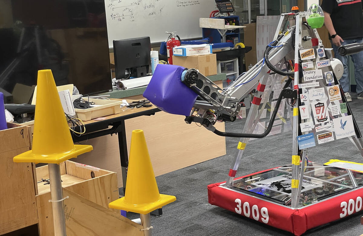 The robot created by the team at Boulder City High School begins to place a block on a stand as ...