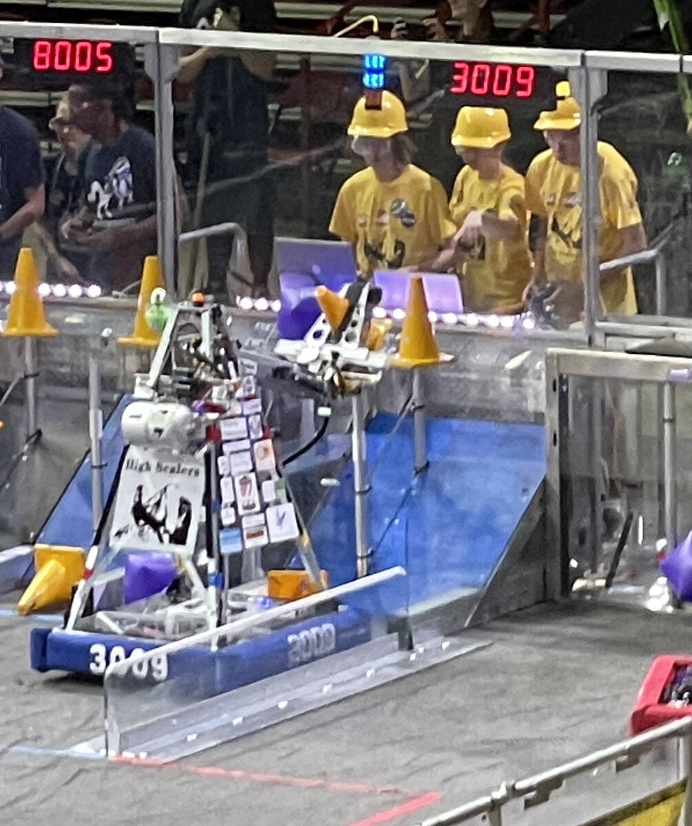High Scaler team members guide the robot during a qualifying match. Thomas and Mack Center, Mar ...