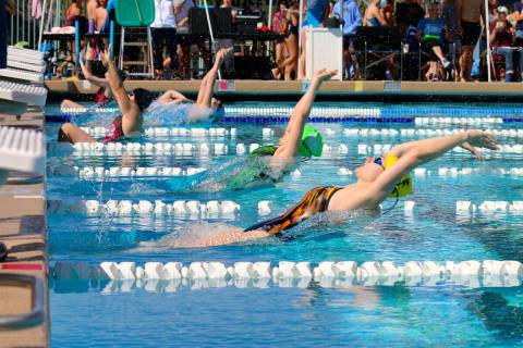 Junior Sarah Estes explodes off the wall doing backstroke as the leadoff swimmer in the 100 ind ...