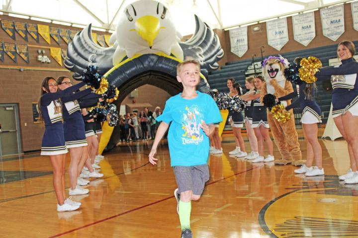 Fourth grader Ryder Charlesworth runs through the Eagle tunnel after his named was announced. ( ...
