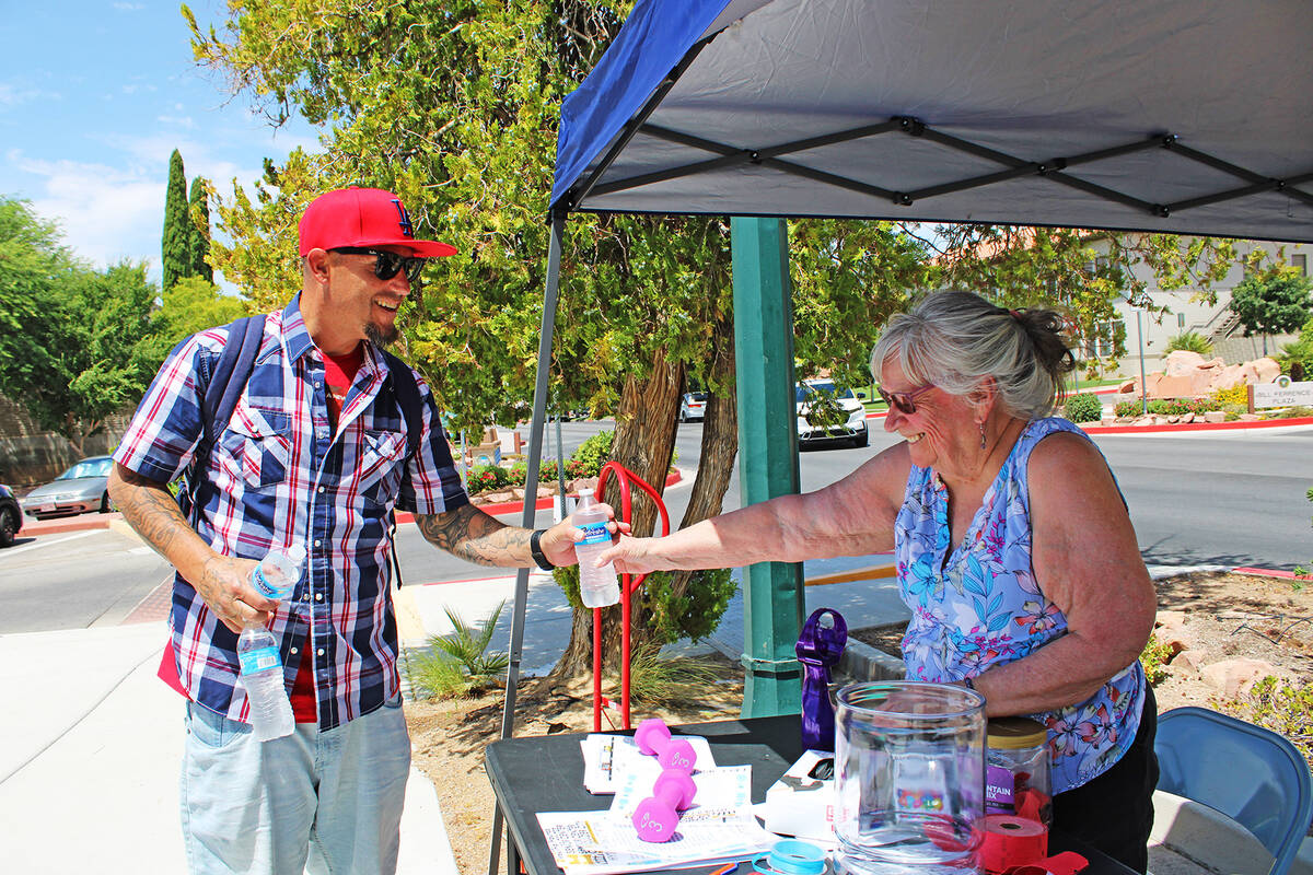 Ron Eland/Boulder City Review Boulder City Senior Center volunteer Kevin Kern, right, hands a b ...