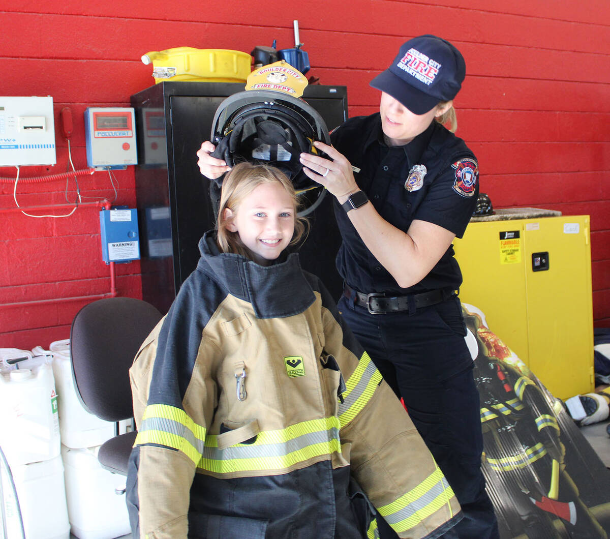 Nine-year-old Peyton Walton receives a helping hand from Boulder City firefighter Sarah Mitre d ...