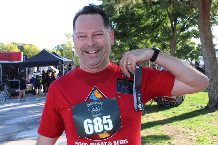 Michael Salay, a 1987 BCHS grad, displays his medal just after crossing the finish line in the ...