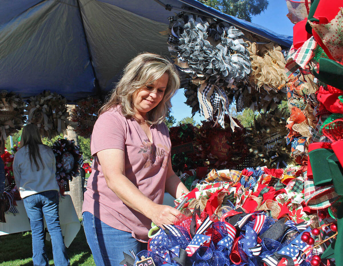 Kelly (Mead) McDonald, a 1985 BCHS graduate, arranges some of her handmade wreaths in her booth ...