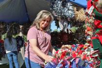 Kelly (Mead) McDonald, a 1985 BCHS graduate, arranges some of her handmade wreaths in her booth ...