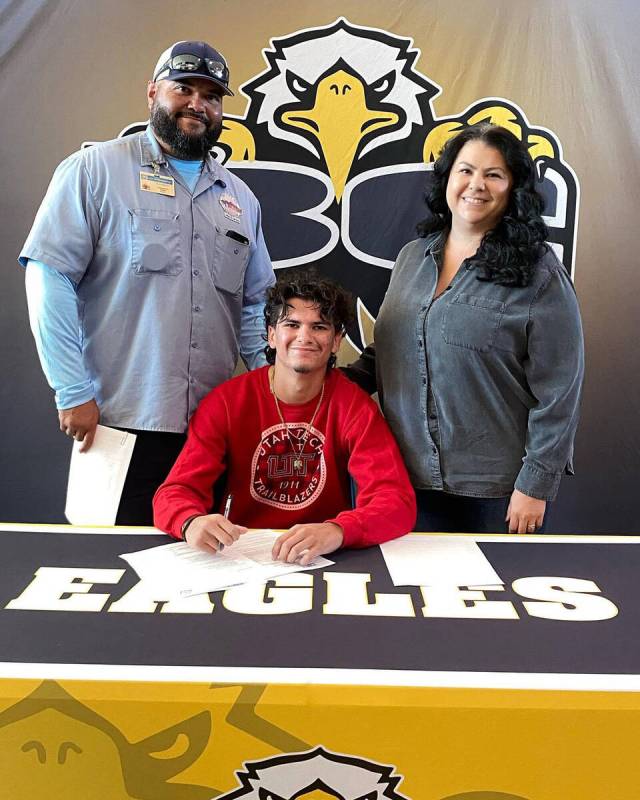 Photo courtesy Boulder City High School Derek Render with his parents on National Signing Day. ...