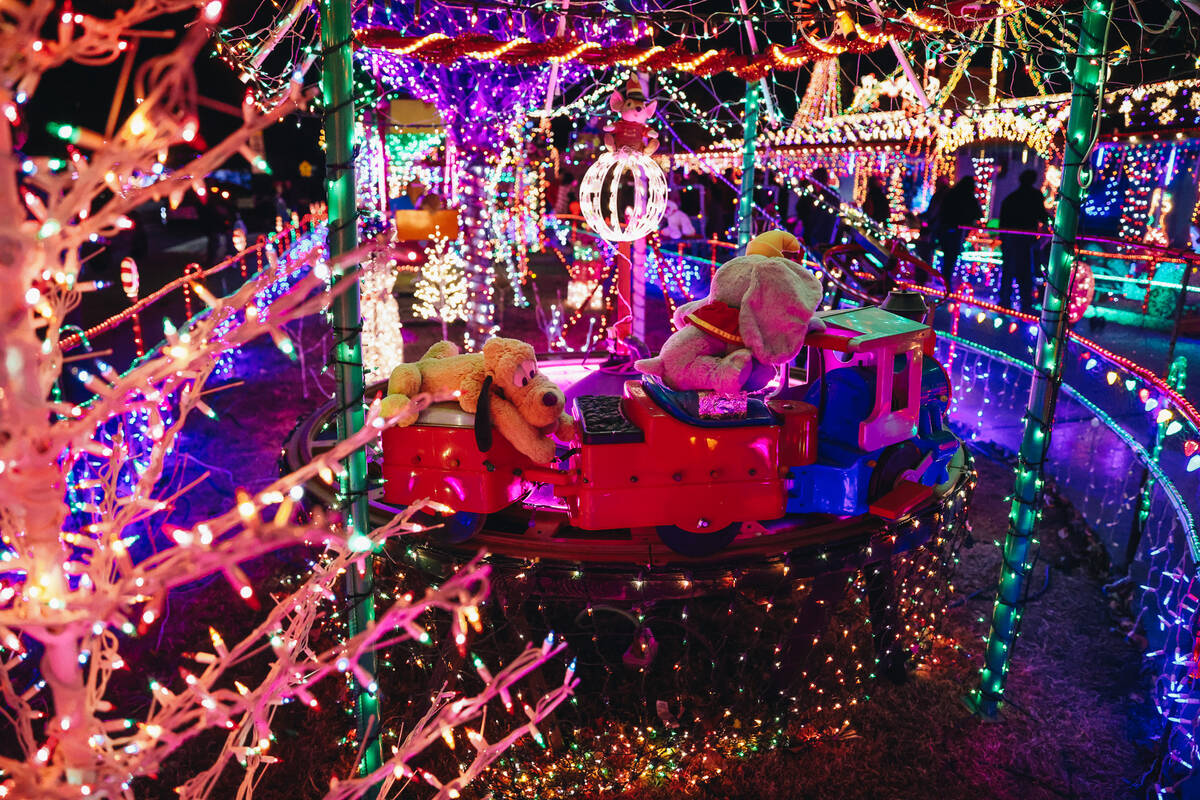 People stroll through the yard of Dale Ryan and Dyanah Musgrave on Sunday, Dec. 3, 2023, in Bou ...