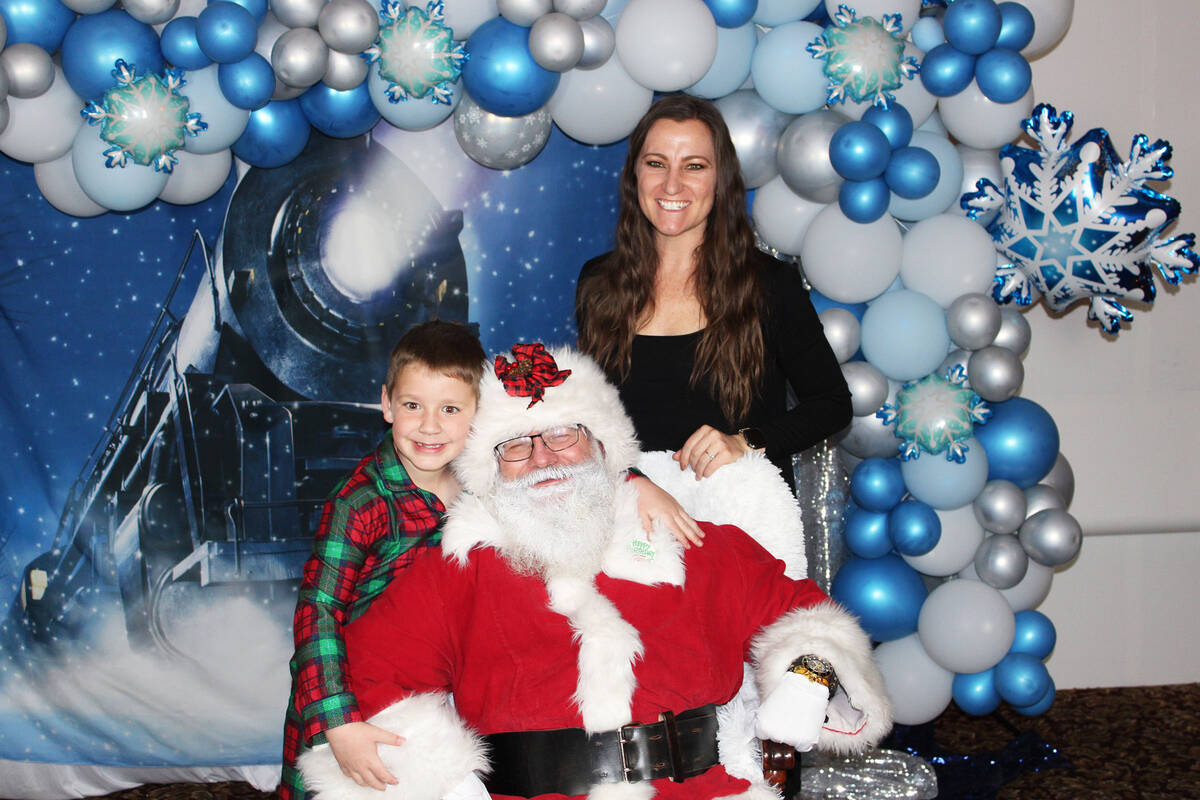 Sunny Wilcoxen and her son Dane were two of many who met with Santa for photos near the end of ...