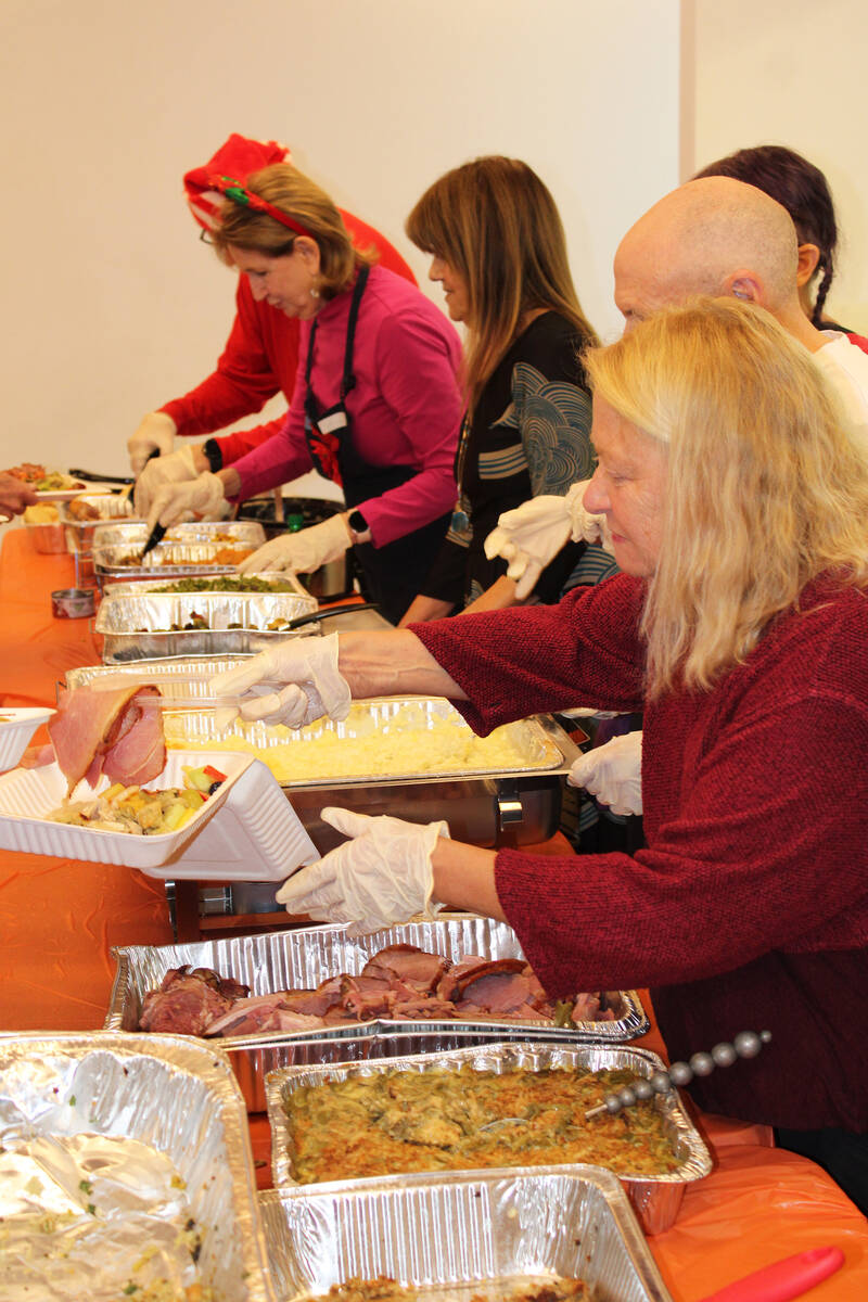 Ron Eland/Boulder City Review Volunteers served nearly 200 people Christmas afternoon during a ...