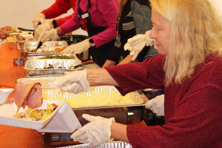 Ron Eland/Boulder City Review Volunteers served nearly 200 people Christmas afternoon during a ...