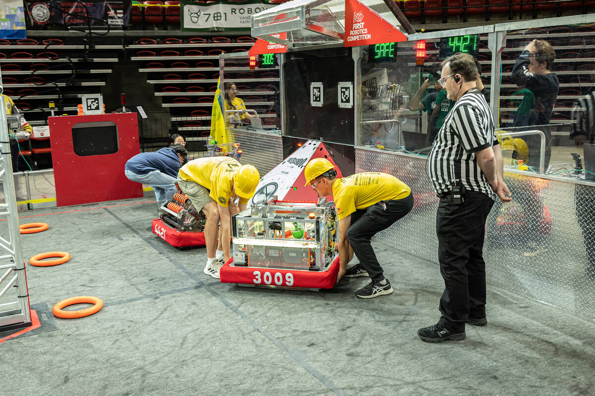 Photo courtesy of Yenor Photos Ben Porter and Bennet Forney set this year’s robot into the a ...