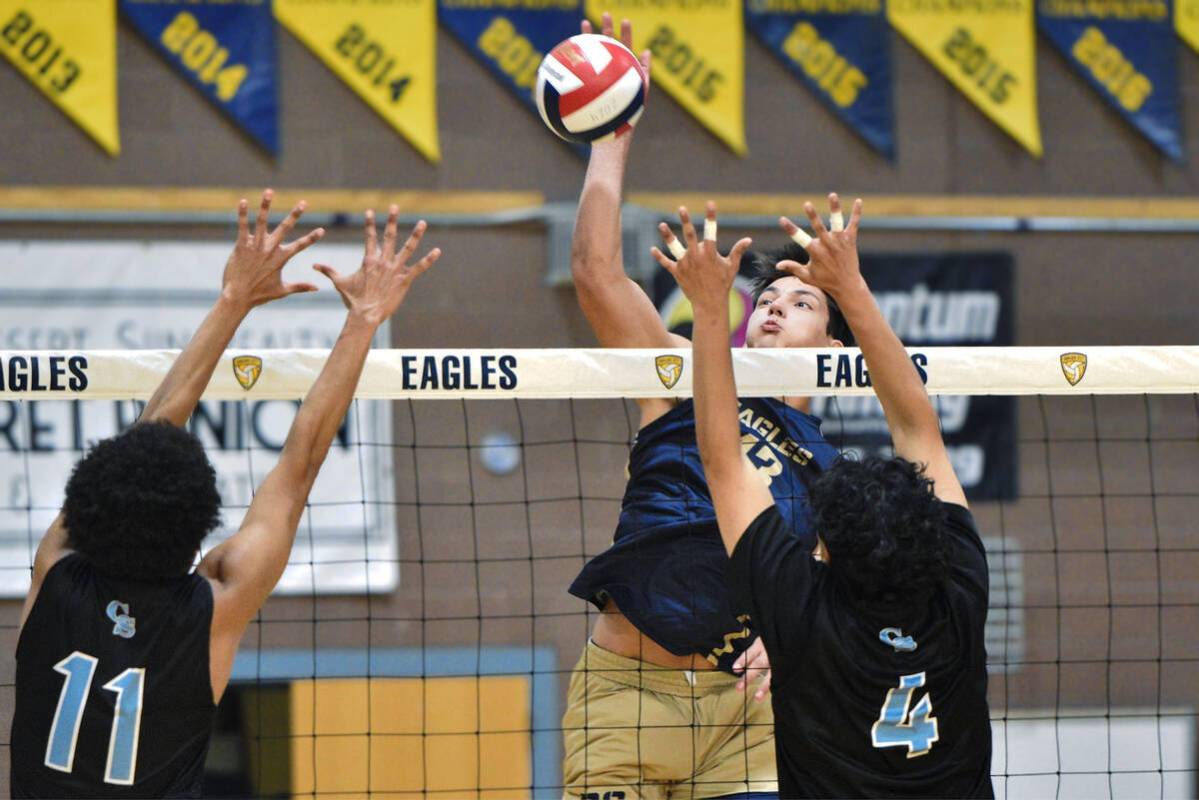 Robert Vendettoli/Boulder City Review Senior Travis Hess soars above the net for a thunderous k ...